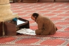a newspaper pause in the mosque